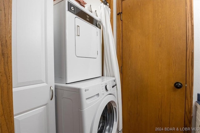 washroom with stacked washer and clothes dryer