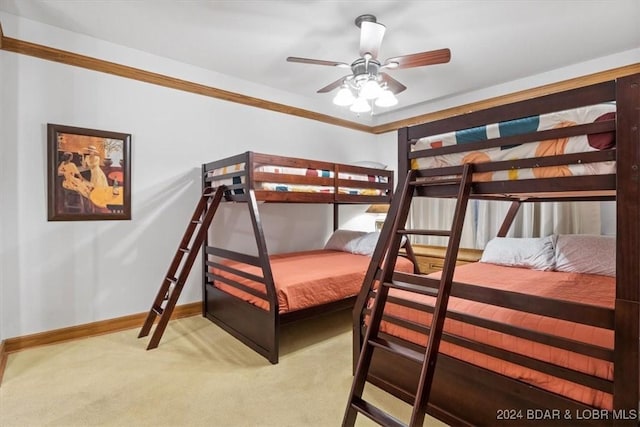 bedroom featuring carpet, ceiling fan, and crown molding