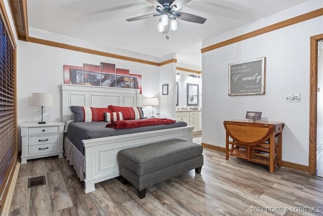 bedroom featuring ensuite bathroom, ceiling fan, and light wood-type flooring