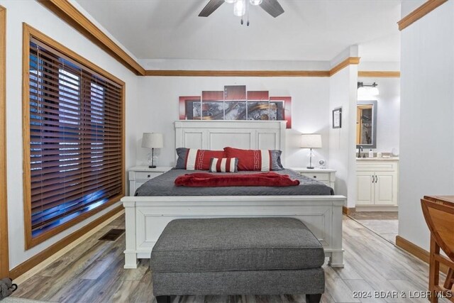 bedroom featuring ceiling fan, ensuite bathroom, and light hardwood / wood-style floors