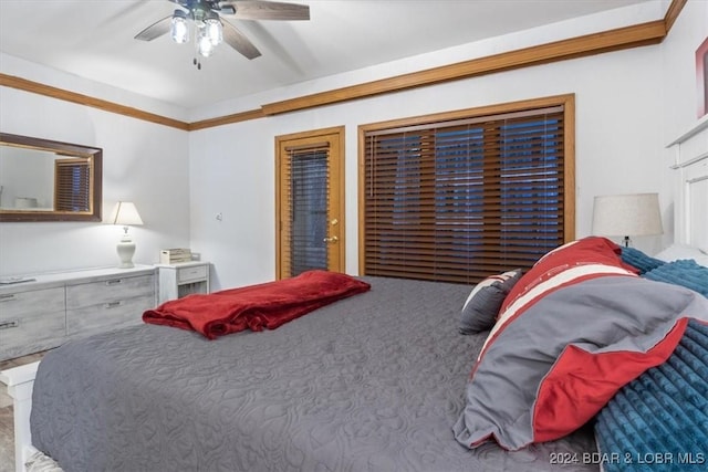 carpeted bedroom with ceiling fan and crown molding