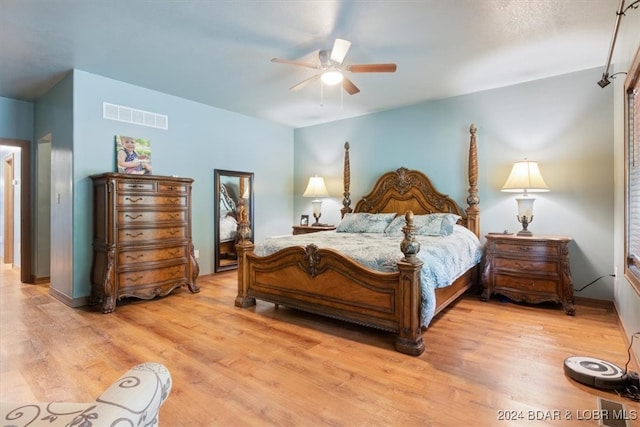 bedroom with ceiling fan and light hardwood / wood-style flooring