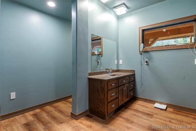 bathroom with vanity and hardwood / wood-style floors