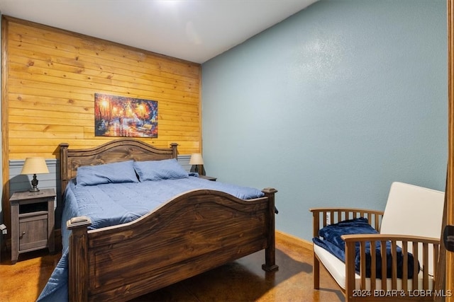 bedroom with carpet floors and wooden walls