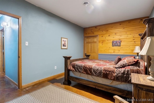 bedroom with wooden walls