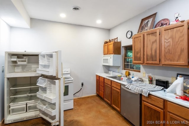 kitchen featuring light carpet, white appliances, and sink