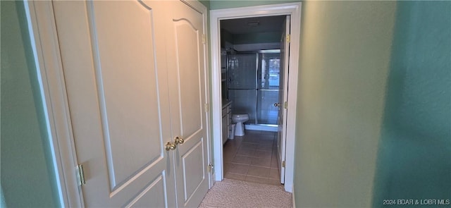 hall with light tile patterned floors