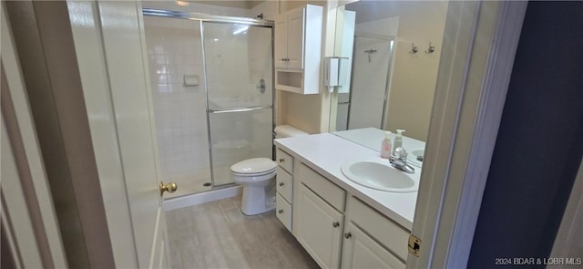 bathroom with toilet, vanity, wood-type flooring, and walk in shower