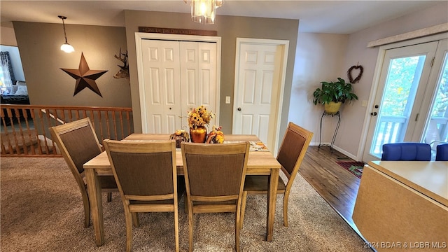 dining area featuring a chandelier and dark wood-type flooring