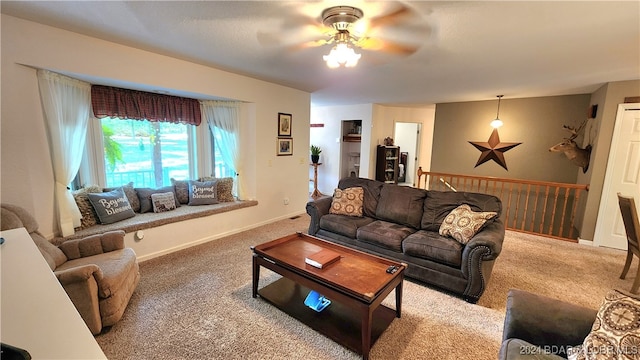 carpeted living room with ceiling fan