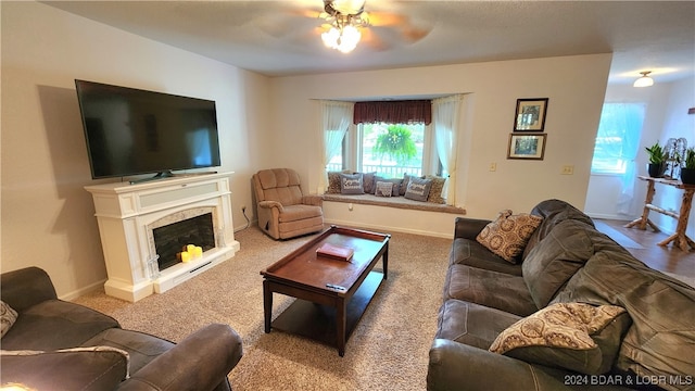 living room featuring carpet floors and ceiling fan