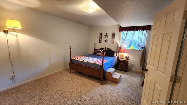 bedroom featuring carpet and a textured ceiling