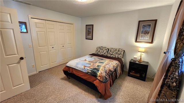 carpeted bedroom featuring a closet