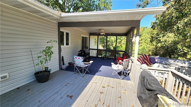 wooden terrace with a grill and ceiling fan