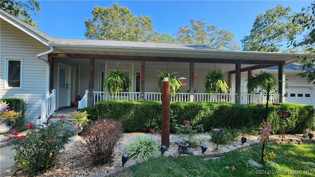 exterior space featuring a porch and a garage