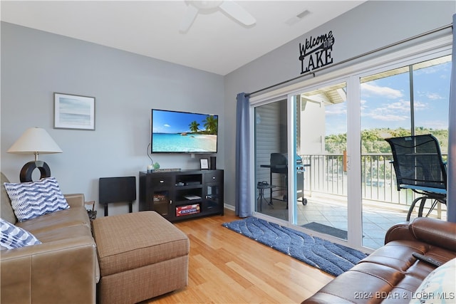 living room featuring hardwood / wood-style floors and ceiling fan