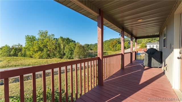 wooden terrace with a lawn