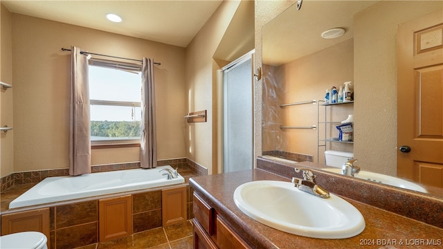 full bathroom with tile patterned flooring, separate shower and tub, vanity, and toilet