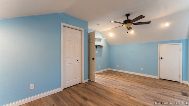 additional living space with lofted ceiling, ceiling fan, and light wood-type flooring