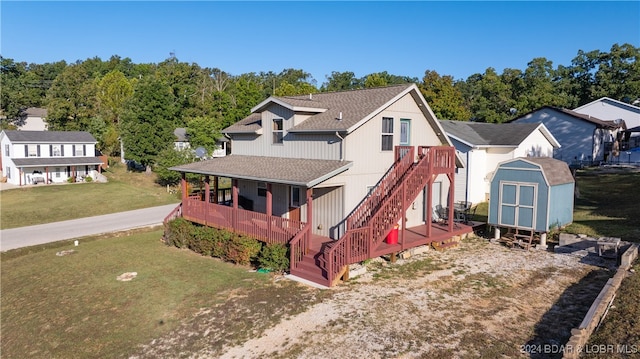 view of front facade featuring a deck, a storage shed, and a front yard