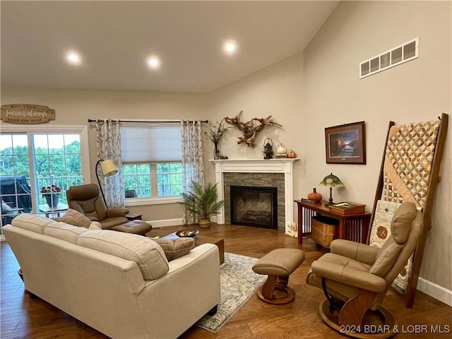 living room featuring dark wood-type flooring and vaulted ceiling