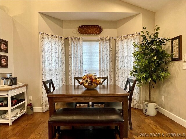 dining space with hardwood / wood-style flooring