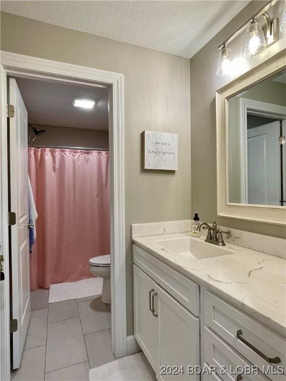 bathroom featuring a shower with shower curtain, vanity, a textured ceiling, tile patterned floors, and toilet