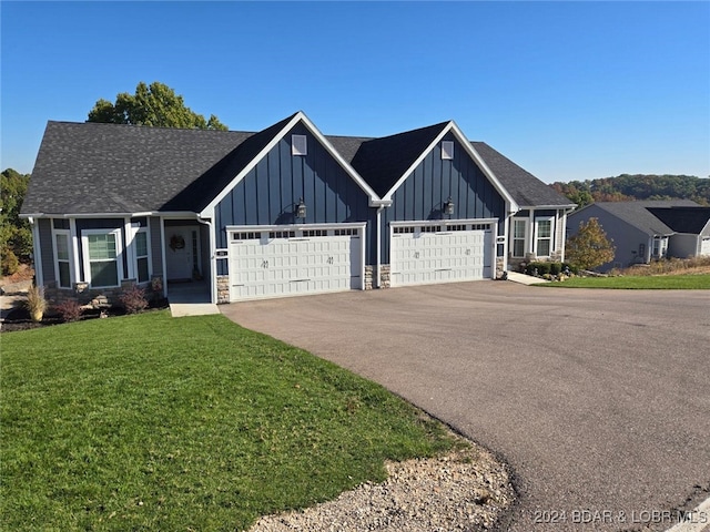 view of front of property featuring a garage and a front yard