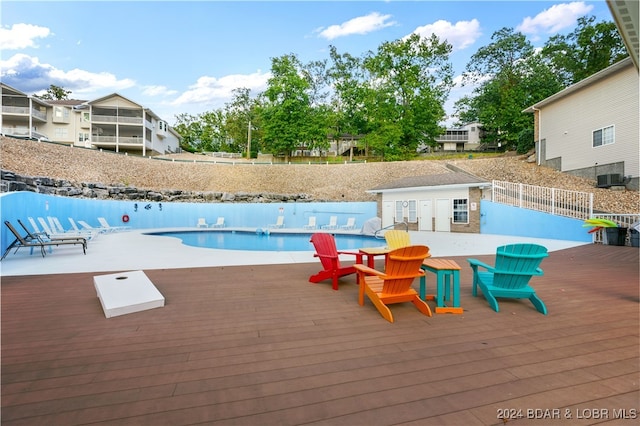 view of swimming pool with a wooden deck