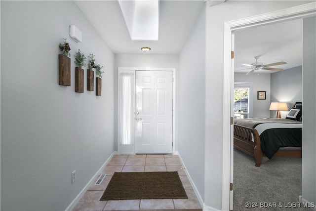 entrance foyer featuring ceiling fan and light tile patterned floors