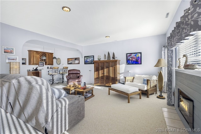 living room featuring a fireplace and carpet flooring