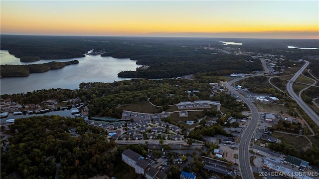 959 High St, Osage Beach, MO 65065 - aerial view at dusk with a water view and a view of trees