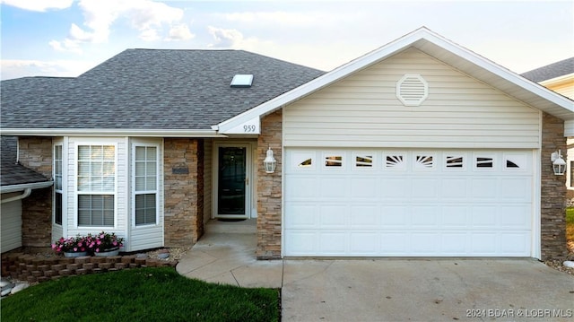 959 High St, Osage Beach, MO 65065 - view of front of property featuring roof with shingles, driveway, an attached garage, and stone siding