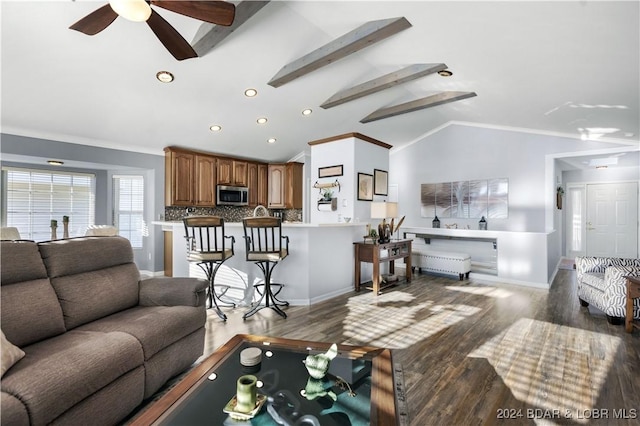 living room with ceiling fan, ornamental molding, lofted ceiling with beams, and hardwood / wood-style floors