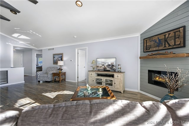 living room with crown molding, lofted ceiling, a large fireplace, and dark hardwood / wood-style floors