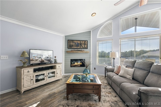 living room with hardwood / wood-style floors, crown molding, vaulted ceiling, and a large fireplace