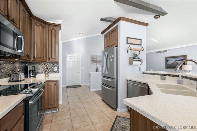 959 High St, Osage Beach, MO 65065 - kitchen with a sink, decorative backsplash, light tile patterned flooring, light countertops, and appliances with stainless steel finishes
