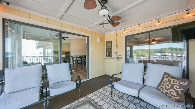 exterior space featuring wooden walls and ceiling fan