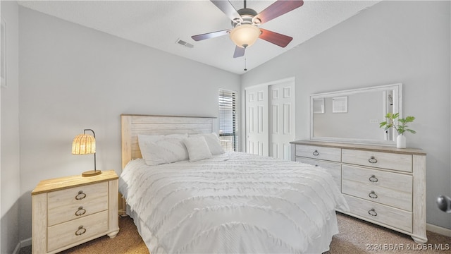 carpeted bedroom with ceiling fan and lofted ceiling