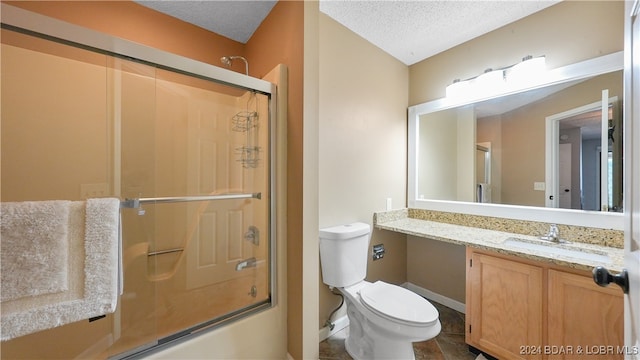 full bathroom with vanity, a textured ceiling, toilet, and combined bath / shower with glass door