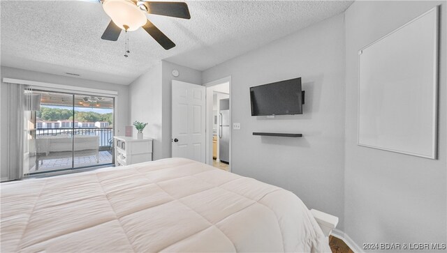 bedroom with access to outside, stainless steel fridge, a textured ceiling, and ceiling fan