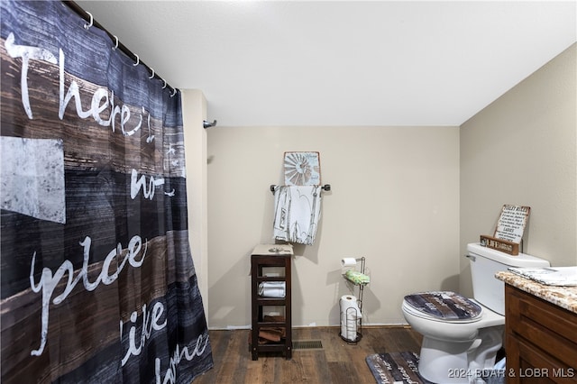 bathroom featuring toilet, a shower with curtain, vanity, and hardwood / wood-style floors