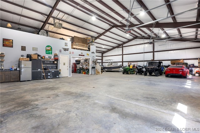 garage with stainless steel refrigerator