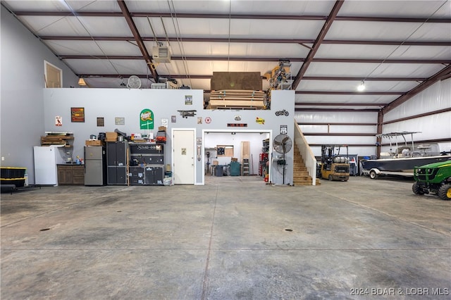 garage with stainless steel refrigerator