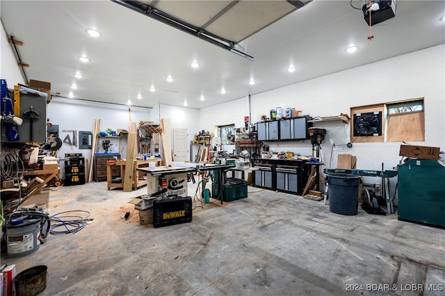 garage with a garage door opener and a workshop area