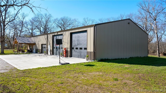 view of outbuilding with a garage and a yard