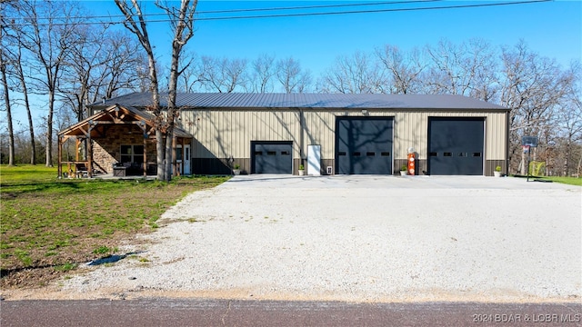 view of outbuilding featuring a lawn and a garage