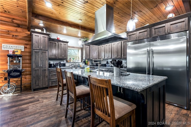 kitchen featuring island range hood, dark wood-type flooring, appliances with stainless steel finishes, and a kitchen island with sink