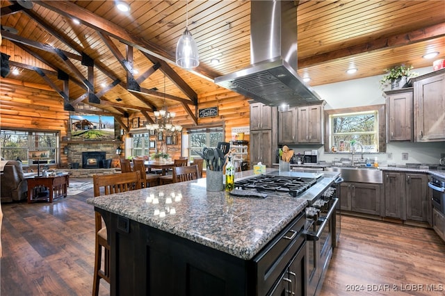 kitchen with a healthy amount of sunlight, island exhaust hood, and a kitchen island