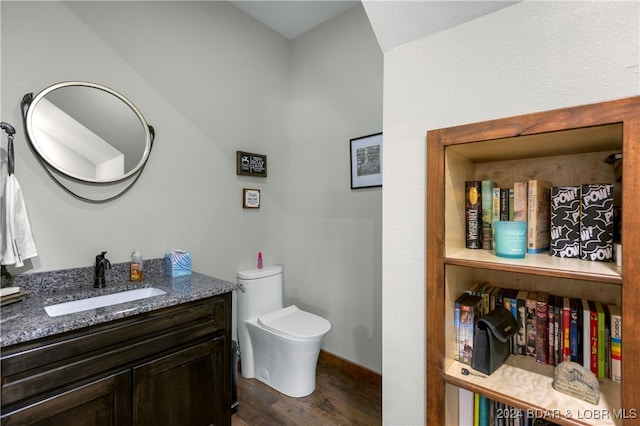 bathroom with toilet, vanity, and hardwood / wood-style flooring